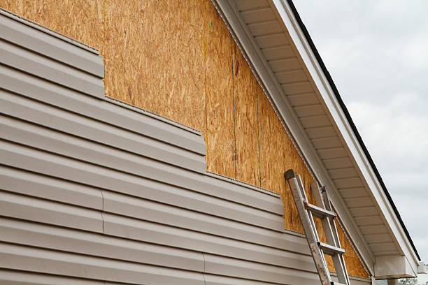 Professional Storm Damage Siding Repair technician working in Utica, IN